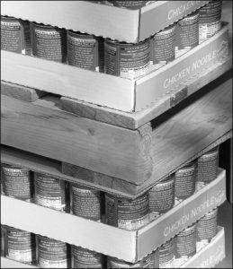 Cans of chicken noodle stacked on top of wooden pallets