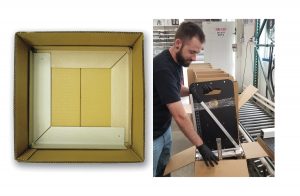 Man packaging a paper cutter into a box with protective products on the corners