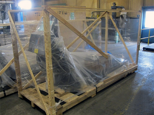 Wooden crate being used to ship a product wrapped in plastic