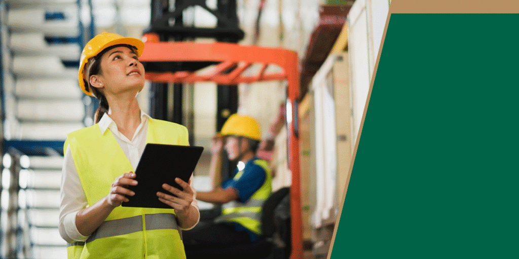 Warehouse worker holding a tablet and looking up