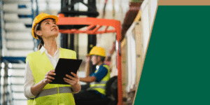 Warehouse worker holding a tablet and looking up