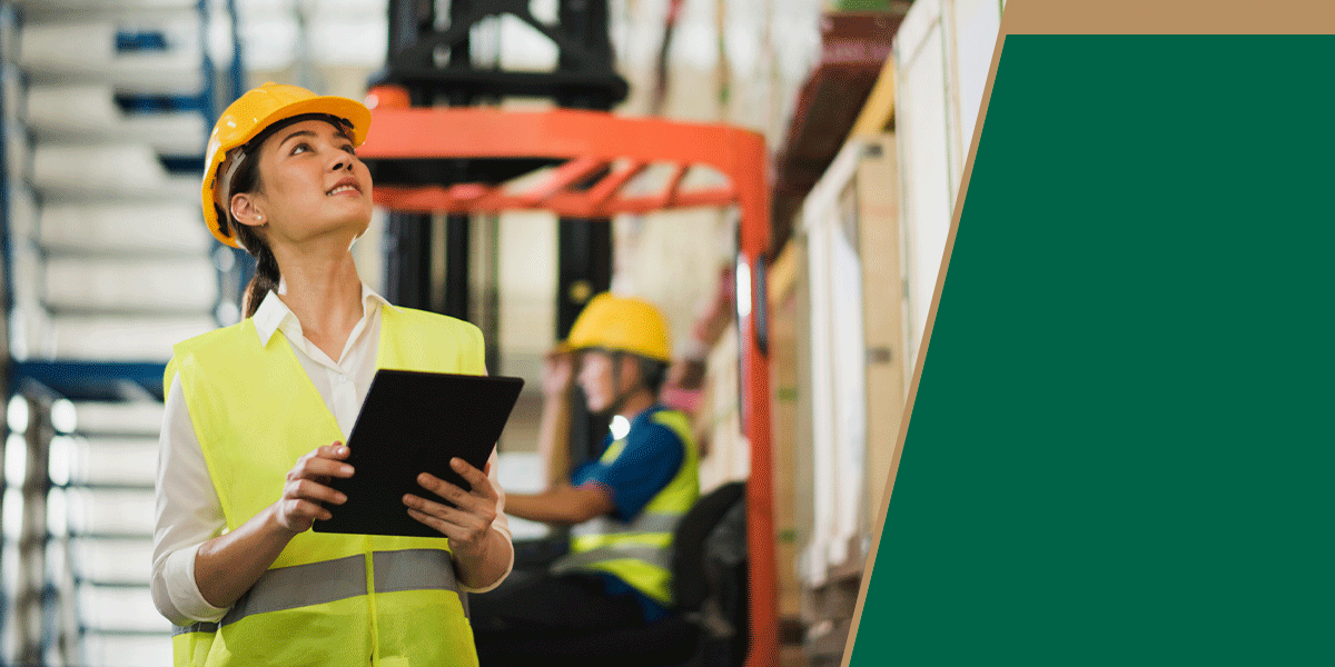 Warehouse worker holding a tablet and looking up